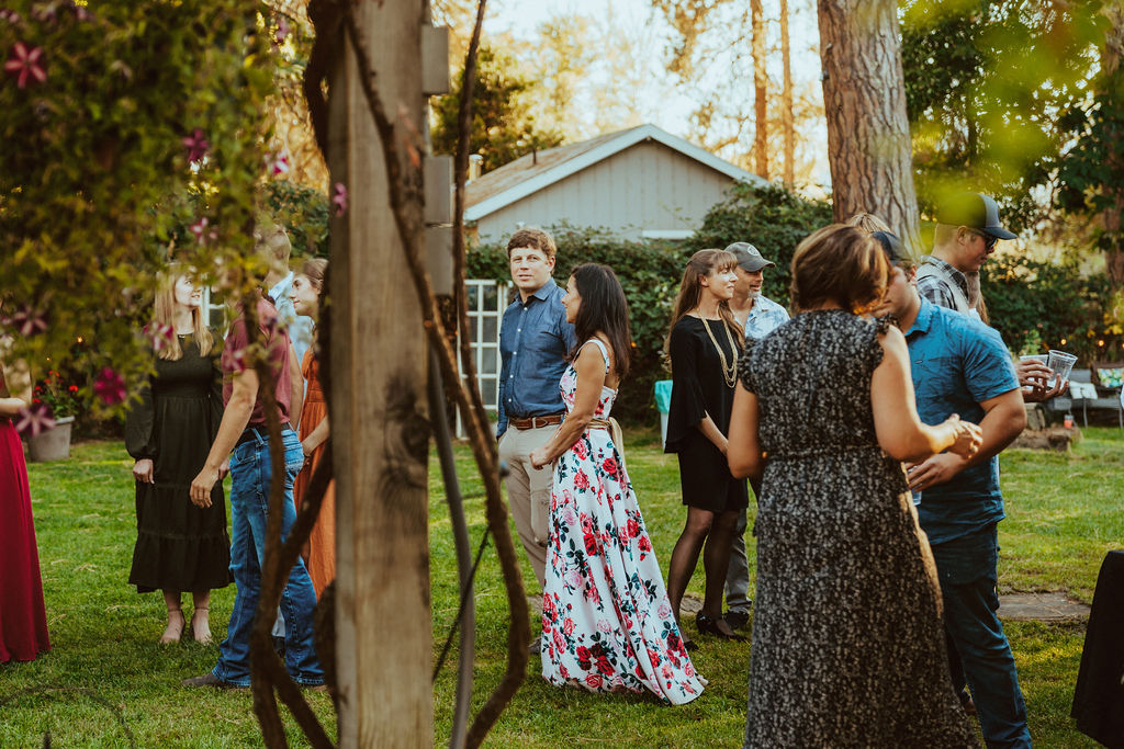 people mingling waiting for the bride and groom to enter the reception 