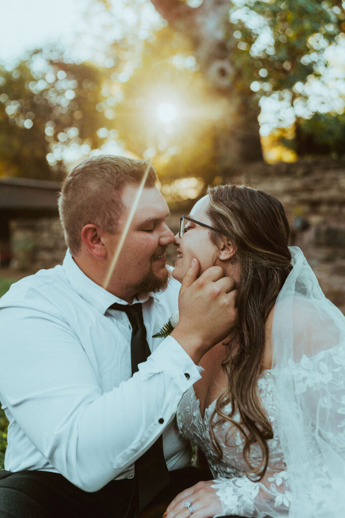 groom about to kiss bride with golden sunshine 