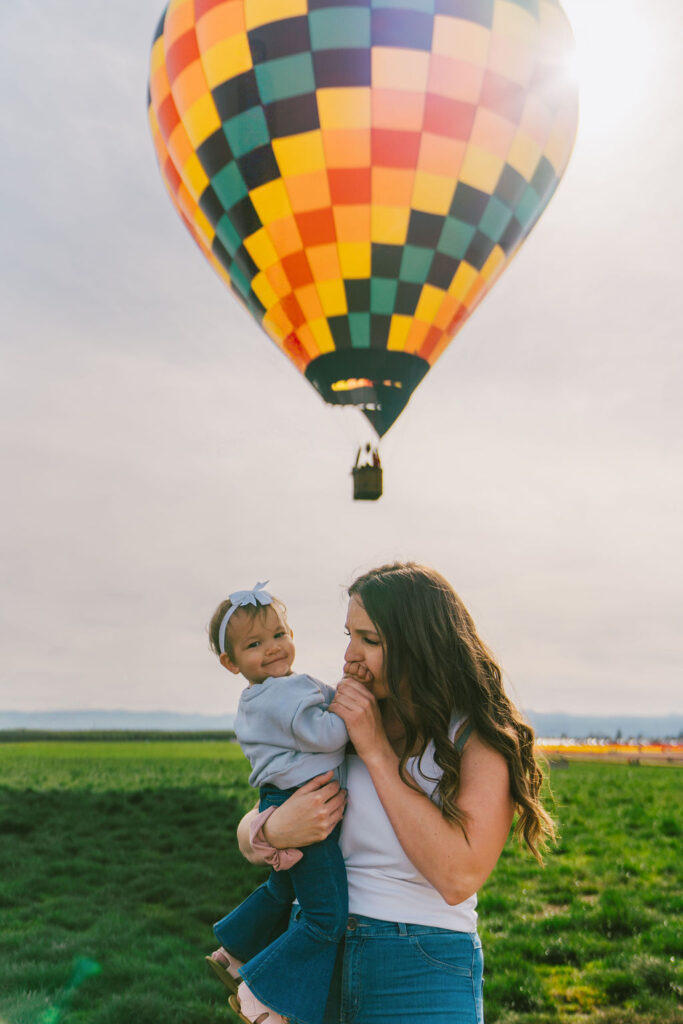 spring mommy and me photos with a hot air balloon in the back 