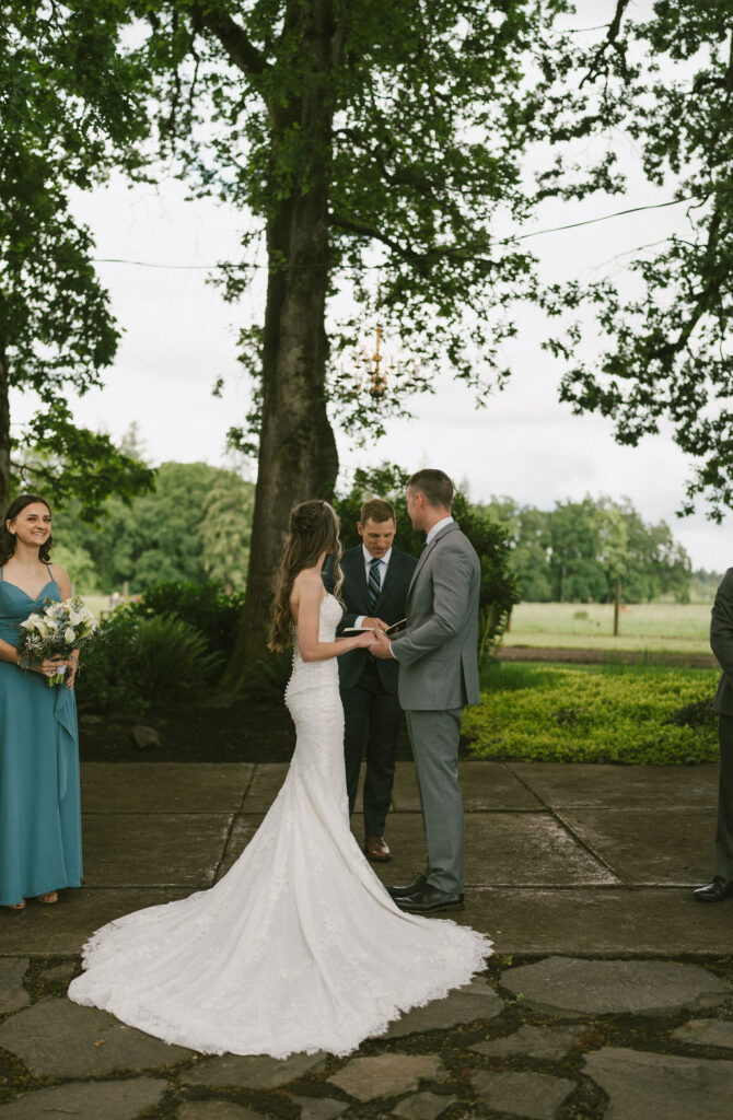 beautiful outdoor wedding showing off the brides wedding dress and train