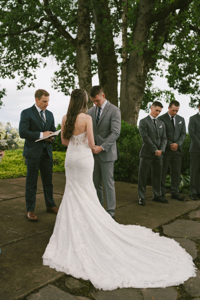 back of brides wedding dress during outdoor spring wedding
