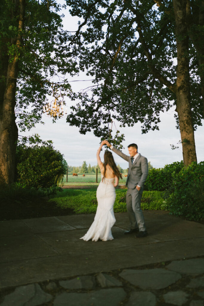 bride and groom dancing outside